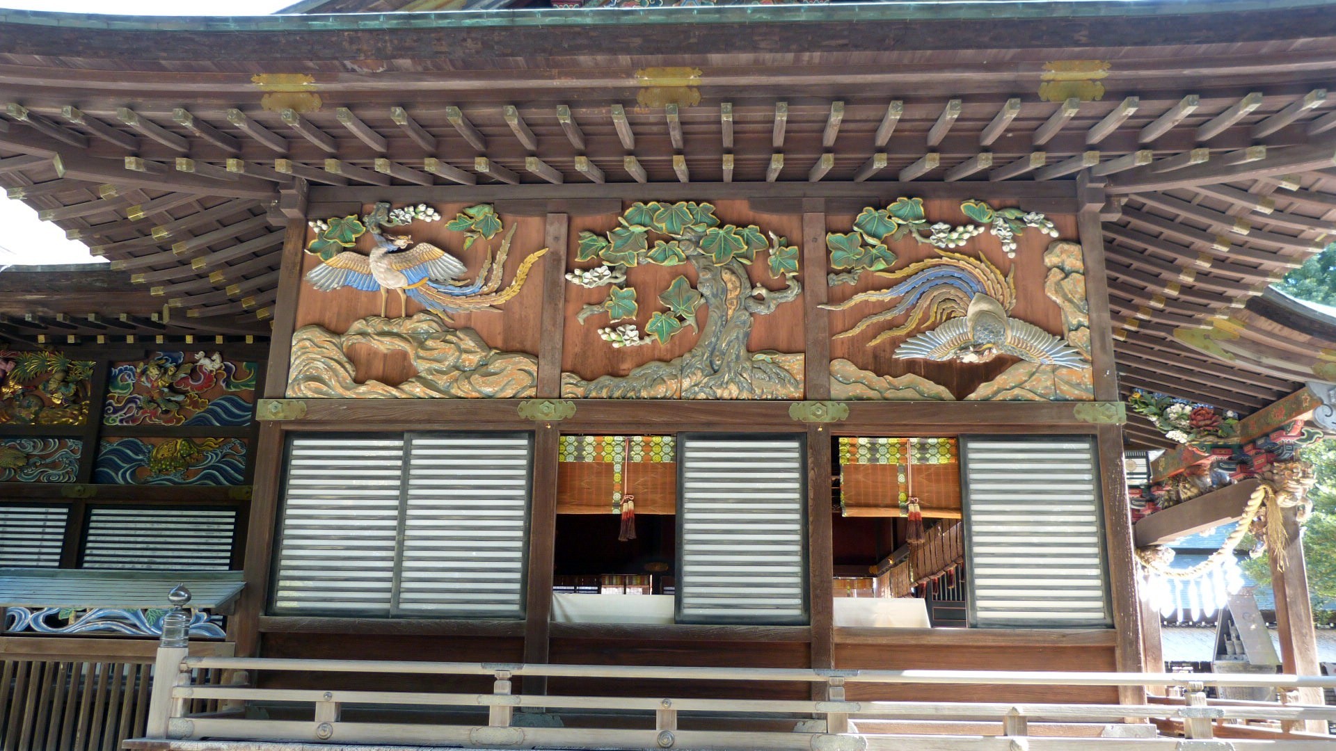 a view of the shrine showing decorative panels of carved and painted wood